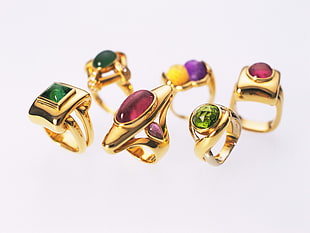 six assorted gemstone encrusted gold-colored rings HD wallpaper